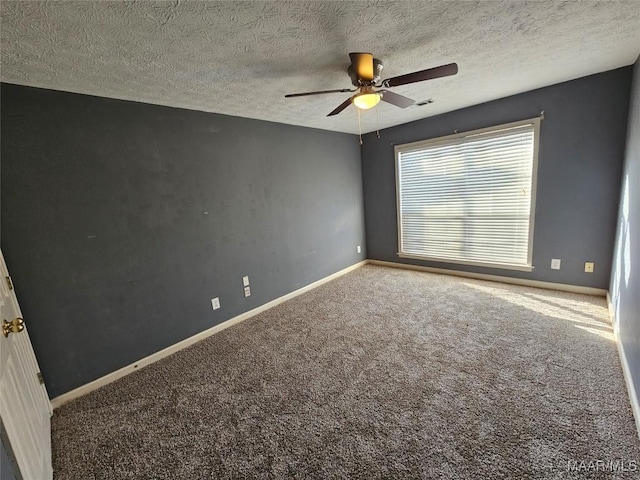 unfurnished room featuring a textured ceiling, carpet floors, a ceiling fan, and baseboards