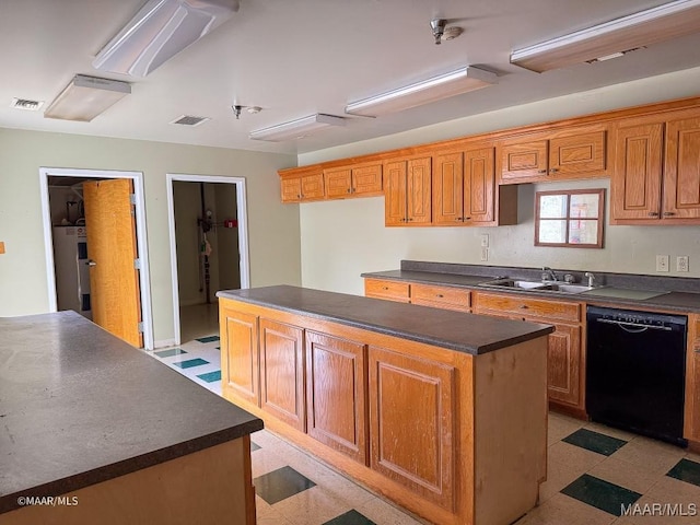 kitchen with a center island, black dishwasher, sink, and water heater