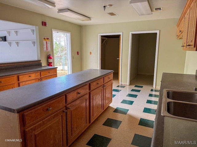 kitchen featuring a center island and sink