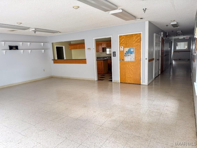 spare room with a textured ceiling