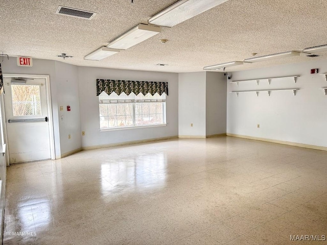 unfurnished room featuring a textured ceiling