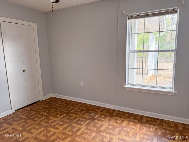 interior space with parquet floors and ceiling fan