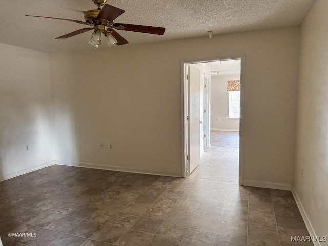 empty room featuring ceiling fan and a textured ceiling