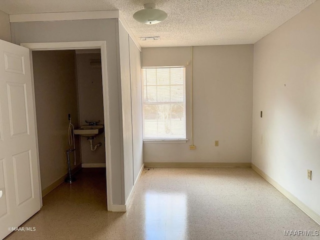 interior space with sink and a textured ceiling