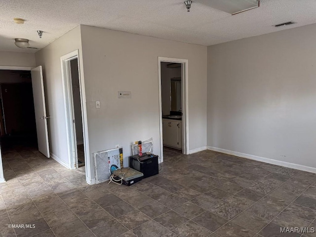 spare room with a textured ceiling