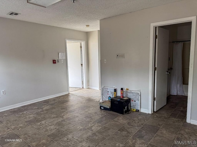 spare room with a textured ceiling