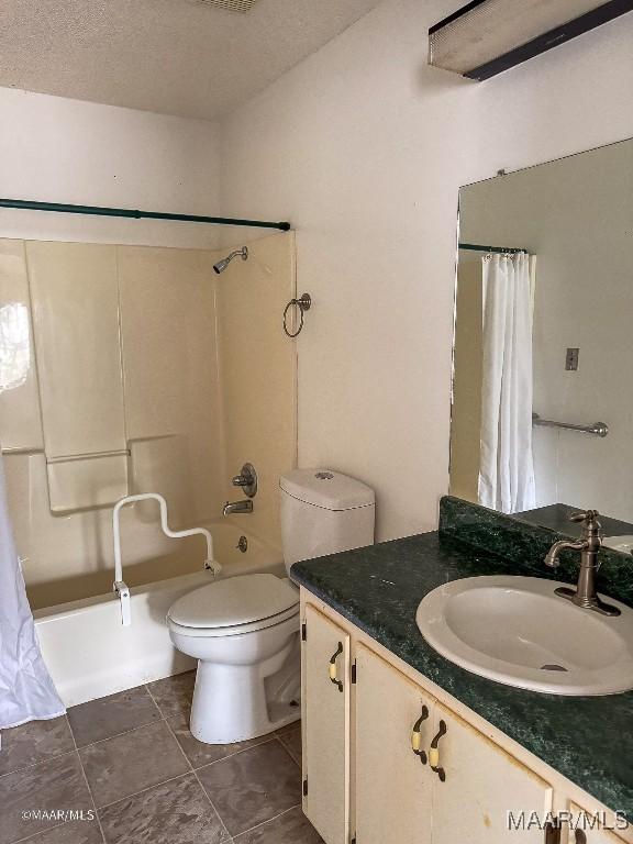 full bathroom featuring tile patterned floors, toilet, shower / tub combo, a textured ceiling, and vanity