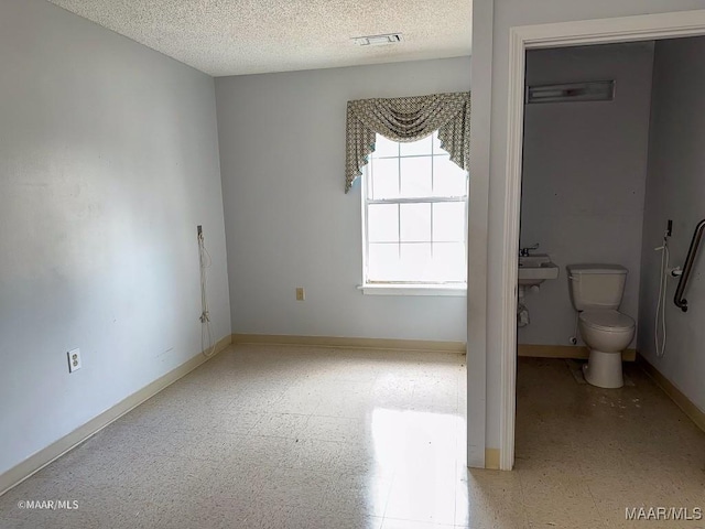 unfurnished bedroom featuring a textured ceiling