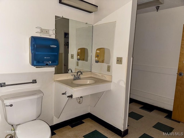 bathroom featuring sink and toilet