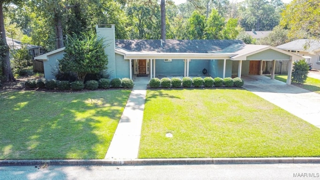 view of front facade featuring an attached carport, a front lawn, concrete driveway, and stucco siding