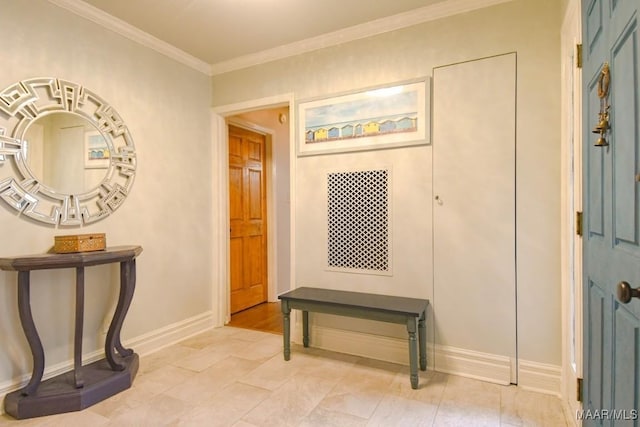 entryway with baseboards and ornamental molding