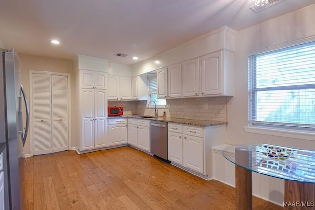 kitchen with light wood finished floors, visible vents, white cabinets, and appliances with stainless steel finishes