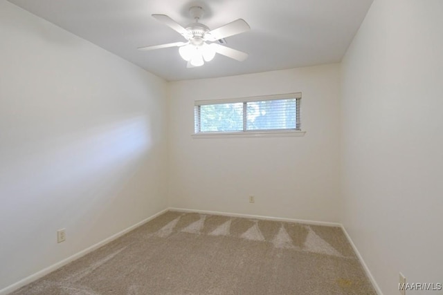 unfurnished room featuring carpet flooring, a ceiling fan, and baseboards