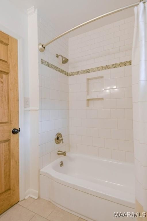 bathroom with tile patterned floors and shower / bath combination with curtain