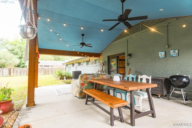 view of patio with outdoor dining space, cooling unit, fence, area for grilling, and ceiling fan