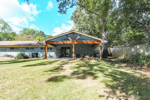 back of house with a patio area, central air condition unit, a yard, and fence
