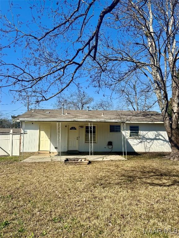 rear view of property with a patio area and a lawn