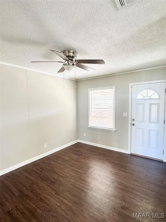 foyer entrance with dark hardwood / wood-style flooring, a textured ceiling, and ceiling fan