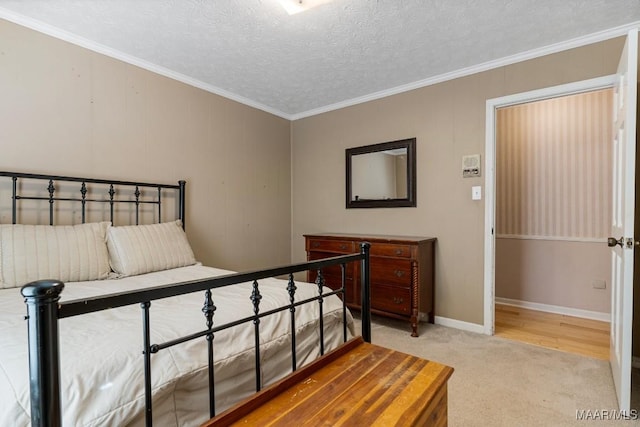 carpeted bedroom with ornamental molding and a textured ceiling