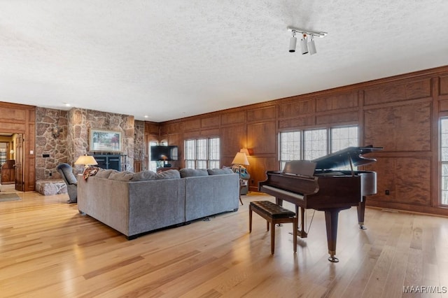 living room with light hardwood / wood-style floors and a textured ceiling