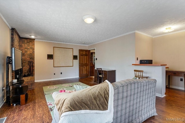 living room featuring ornamental molding, dark hardwood / wood-style flooring, and a textured ceiling