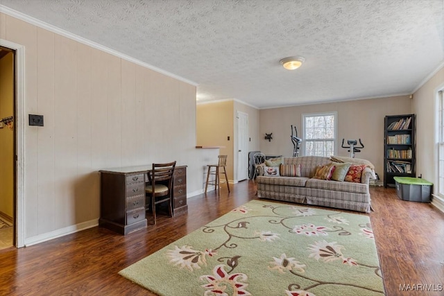 living room with crown molding, dark hardwood / wood-style floors, and a textured ceiling