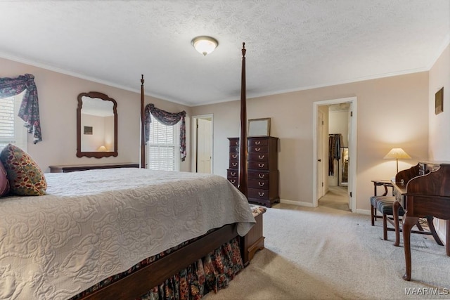 bedroom featuring ornamental molding, light carpet, and a textured ceiling