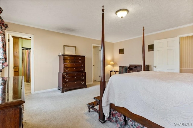 carpeted bedroom featuring ornamental molding and a textured ceiling