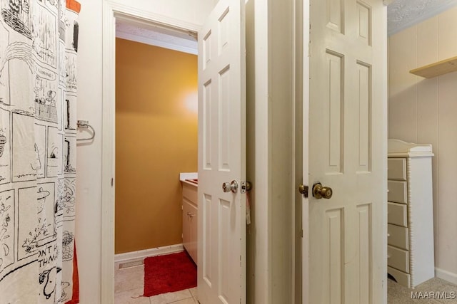 corridor featuring light tile patterned floors