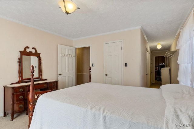 carpeted bedroom featuring ornamental molding and a textured ceiling