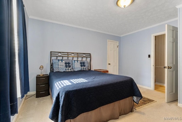 bedroom featuring ornamental molding, carpet floors, and a textured ceiling