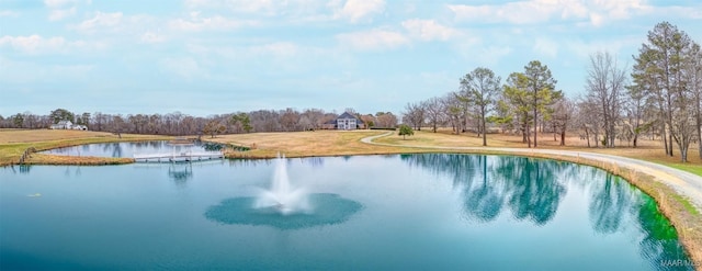 view of swimming pool featuring a lawn and a water view