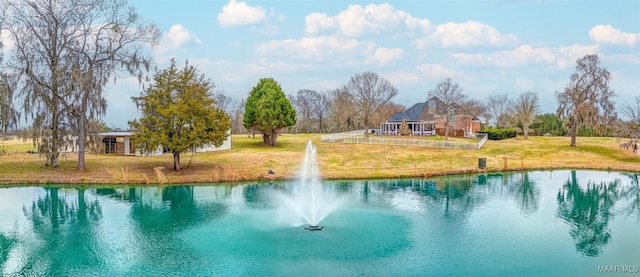 view of swimming pool with a yard and a water view