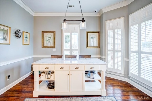 interior space with white cabinetry, dark hardwood / wood-style floors, hanging light fixtures, and crown molding