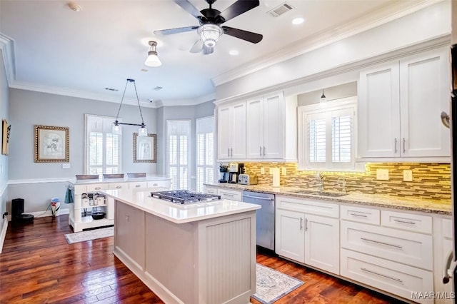 kitchen with pendant lighting, white cabinetry, appliances with stainless steel finishes, and sink