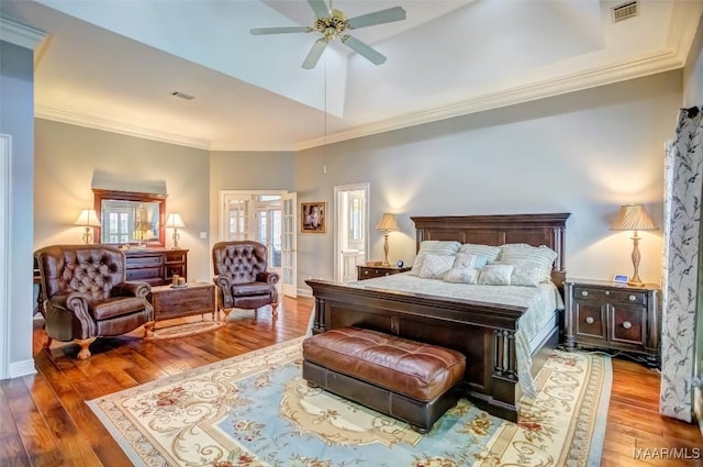 bedroom with crown molding, hardwood / wood-style floors, and ceiling fan