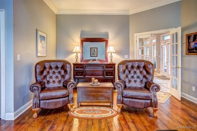 living area with french doors, ornamental molding, and hardwood / wood-style floors