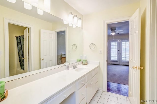 bathroom featuring tile patterned flooring, vanity, shower / bath combination with curtain, and french doors