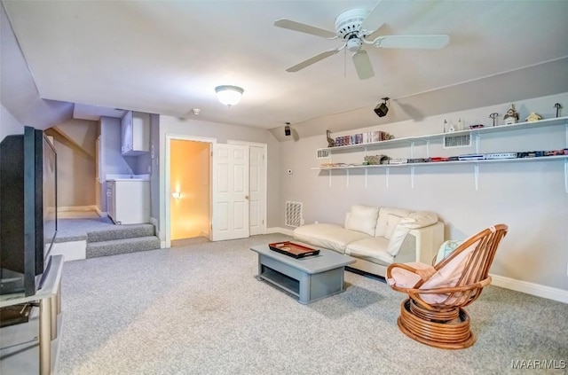 carpeted living room featuring ceiling fan