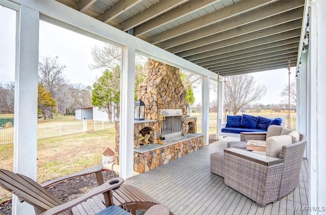 deck with an outdoor stone fireplace