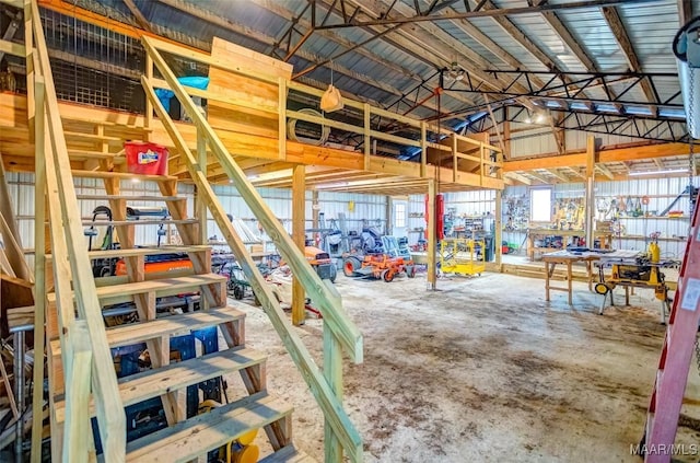 interior space featuring lofted ceiling and concrete floors