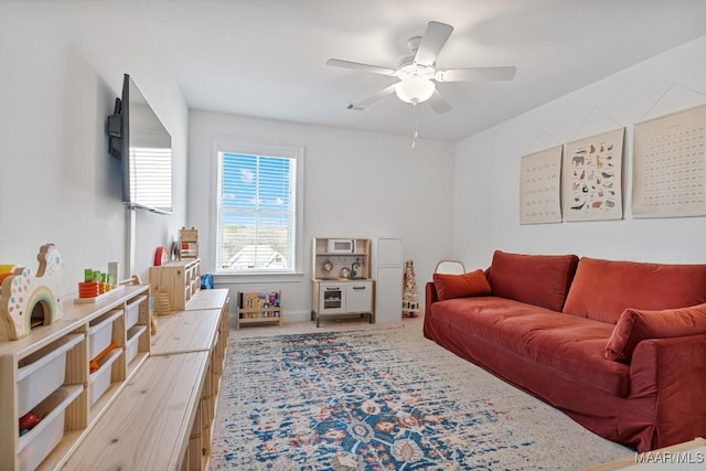 living room featuring wood-type flooring and ceiling fan