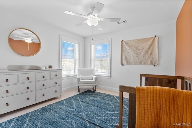 bedroom with ceiling fan and light carpet