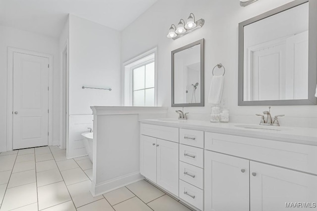 bathroom featuring tile patterned flooring, vanity, and a bathing tub