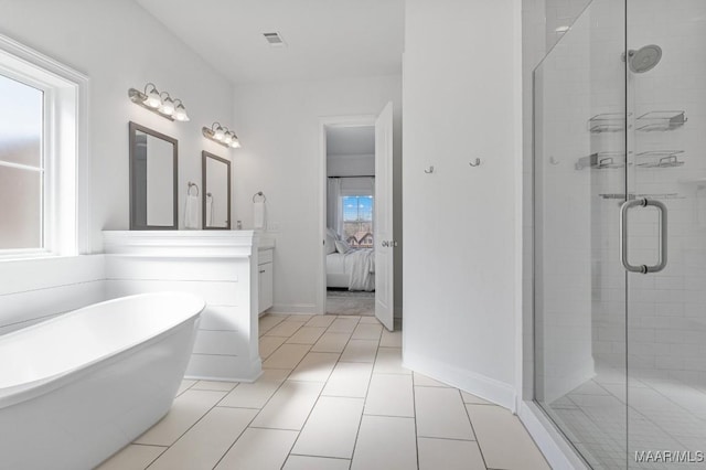 bathroom featuring tile patterned floors, vanity, and shower with separate bathtub