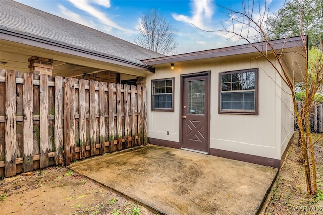 doorway to property with a patio area and fence