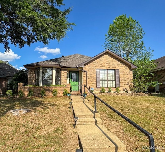 ranch-style home with brick siding and a front yard