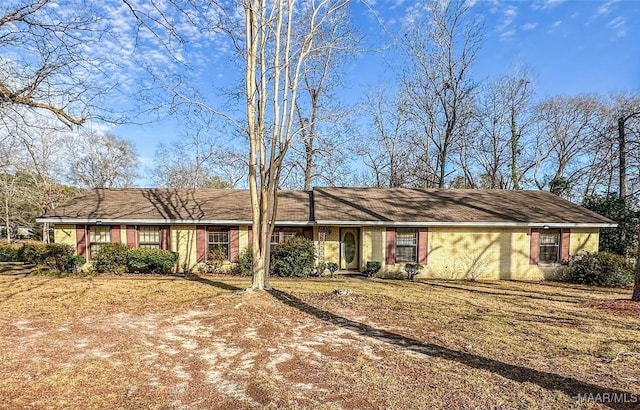 ranch-style house with a front lawn