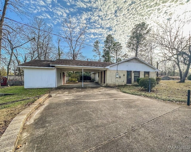 ranch-style home featuring a carport