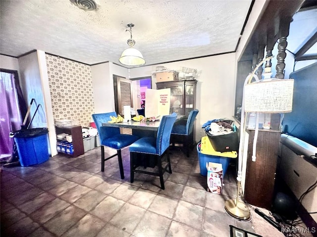 dining space with a textured ceiling